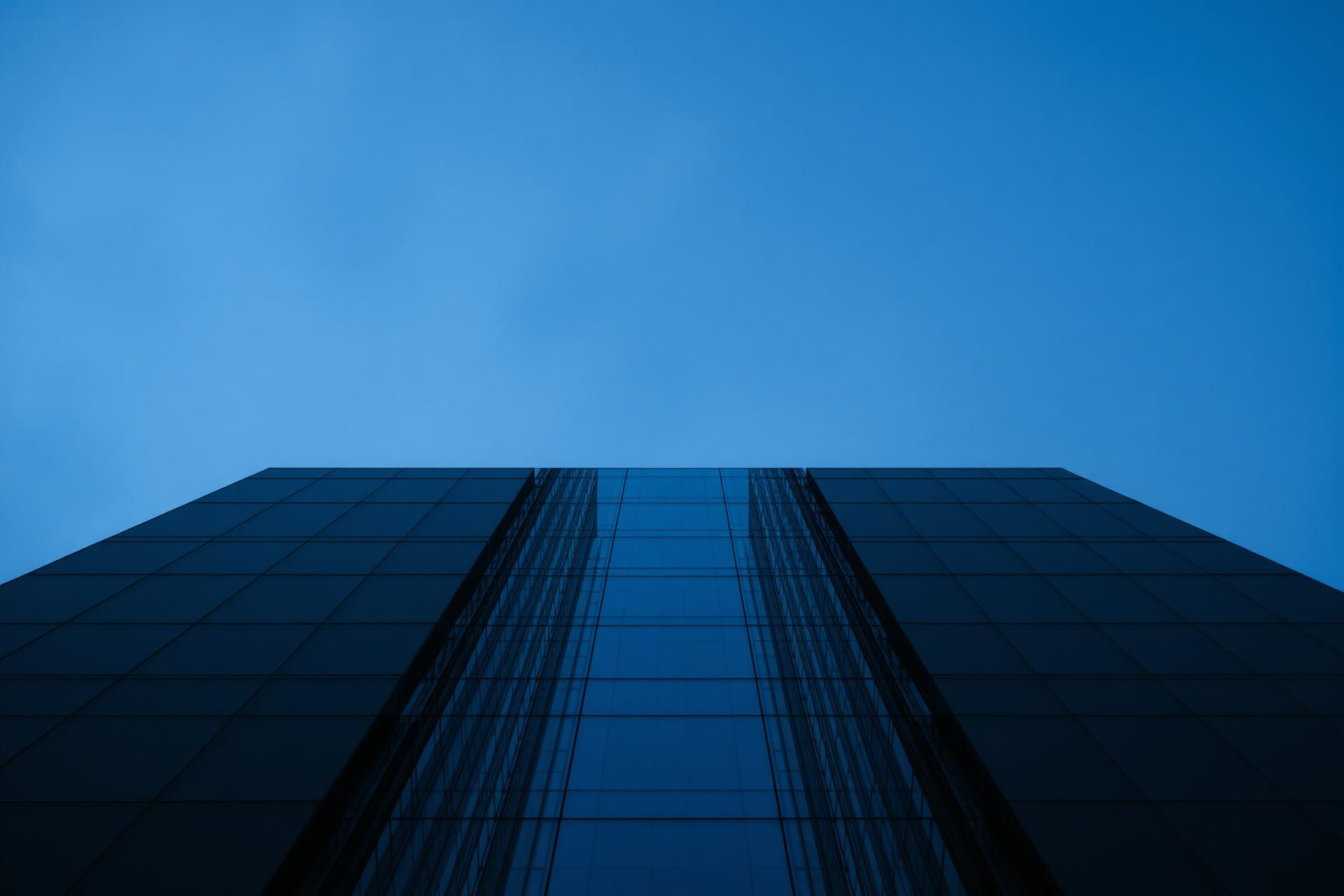 Modern skyscraper viewed from below at dusk